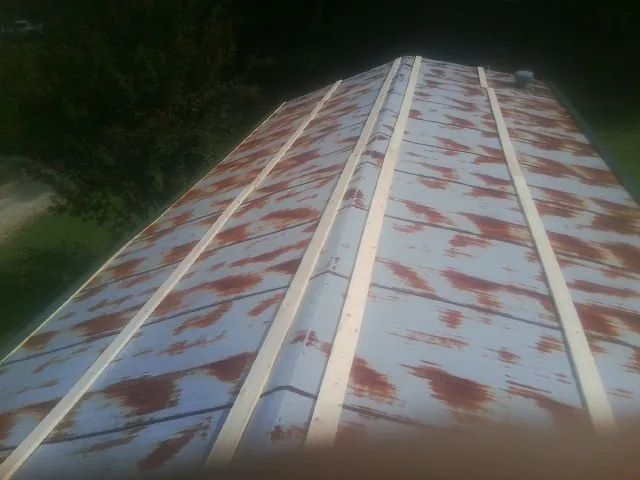 Rusted metal roof panels with new wood purlins before replacement — Storm Damage Roof Repair in Courtenay by Roofing Brothers